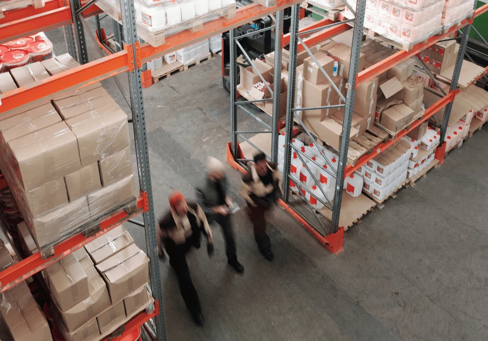 Warehouse team working between storage racks