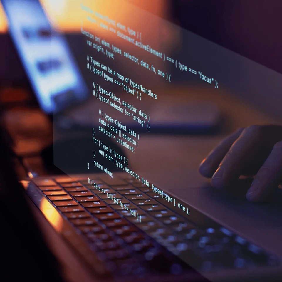 Software code displayed on a laptop screen