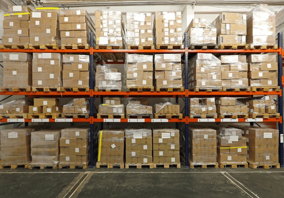 Warehouse shelves stocked with boxes and pallets